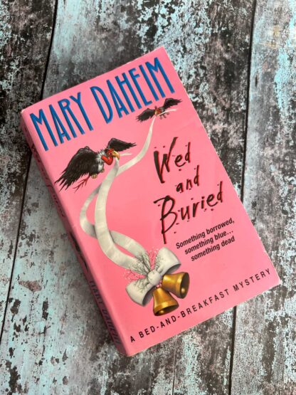 An image of a novel by Mary Daheim - Wed and Buried