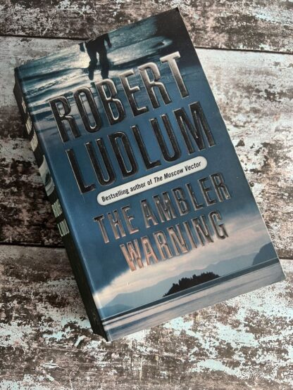 An image of a book by Robert Ludlum - The Ambler Warning
