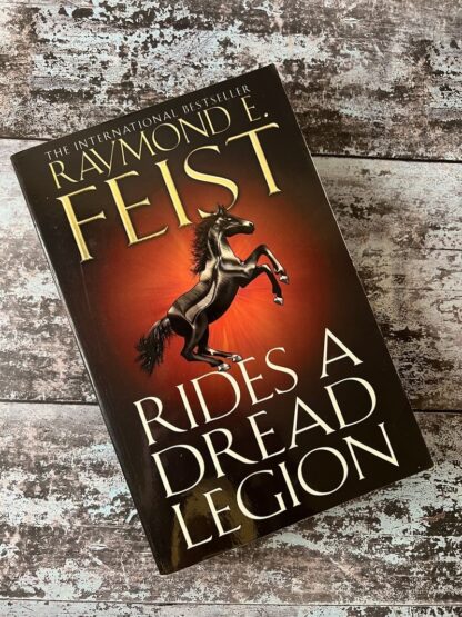 An image of a book by Raymond E Feist - Rides a Dread Legion