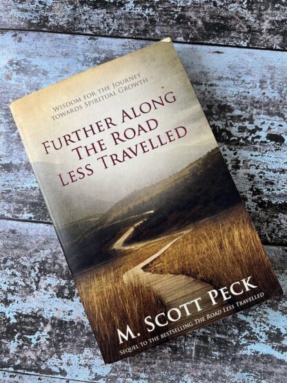 An image of a book by M Scott Peck - Further Along the Road Less Travelled