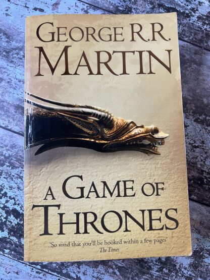 An image of a book by George R R Martin - A Game of Thrones