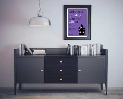 Humorous Jane Eyre print in black frame on wall, with black sideboard and books below. From Bookish Prints collection by StrangeBooks UK