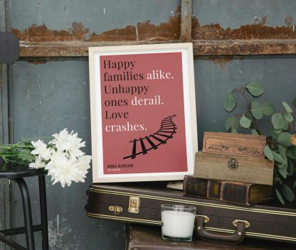 Humorous Anna Karenin print in white wooden frame, perched on a violin case next to some books. From Bookish Prints collection by StrangeBooks UK