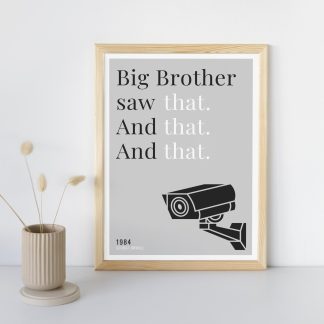 Humorous 1984 print in wooden frame, leaning against a plain wall. Small beige decoration nearby. From Bookish Prints collection by StrangeBooks UK