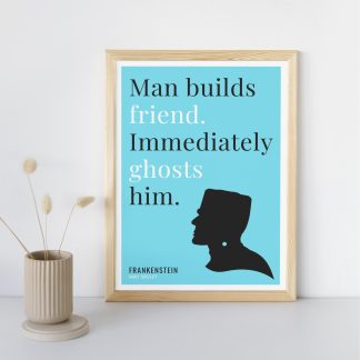 Humorous Frankenstein print in wooden frame, leaning against a plain wall. Small beige decoration nearby. From Bookish Prints collection by StrangeBooks UK