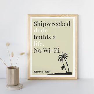 Humorous Robinson Crusoe print in wooden frame, leaning against a plain wall. Small beige decoration nearby. From Bookish Prints collection by StrangeBooks UK