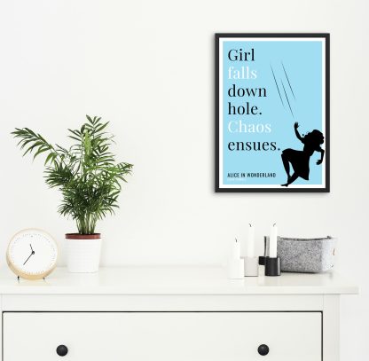 Humorous Alice in Wonderland print in black frame on wall, with white chest of drawers and plants and candles below. From Bookish Prints collection by StrangeBooks UK