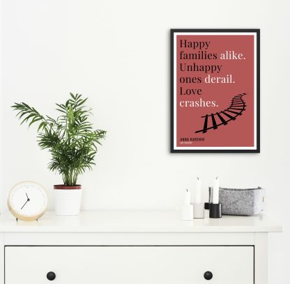 Humorous Anna Karenin print in black frame on wall, with white chest of drawers and plants and candles below. From Bookish Prints collection by StrangeBooks UK