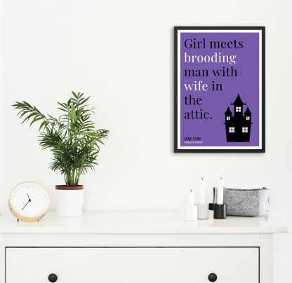 Humorous Jane Eyre print in black frame on wall, with white chest of drawers and plants and candles below. From Bookish Prints collection by StrangeBooks UK