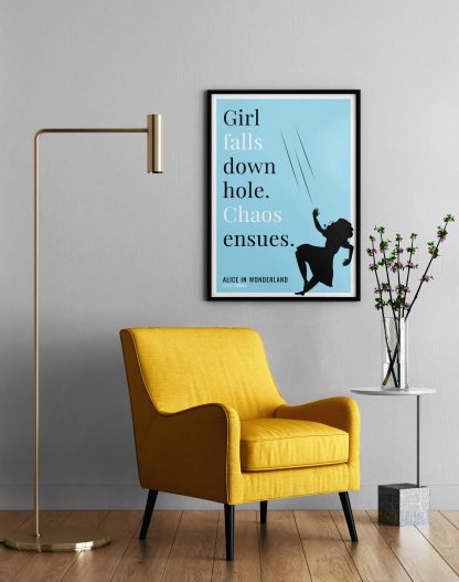 Humorous Alice in Wonderland print in black frame on wall, with a yellow armchair in front next to a tall angular lamp and plant on a table. From Bookish Prints collection by StrangeBooks UK