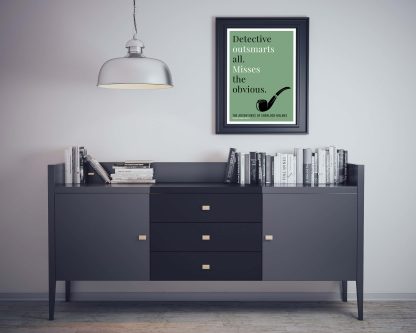 Humorous Adventures of Sherlock Holmes print in black frame on wall, with black sideboard and books below. From Bookish Prints collection by StrangeBooks UK