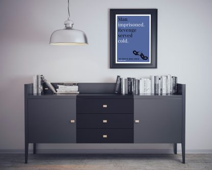 Humorous The Count of Monte Cristo print in black frame on wall, with black sideboard and books below. From Bookish Prints collection by StrangeBooks UK