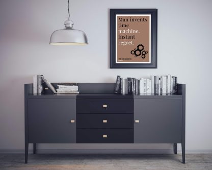 Humorous The Time Machine print in black frame on wall, with black sideboard and books below. From Bookish Prints collection by StrangeBooks UK