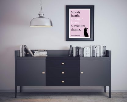 Humorous Wuthering Heights print in black frame on wall, with black sideboard and books below. From Bookish Prints collection by StrangeBooks UK