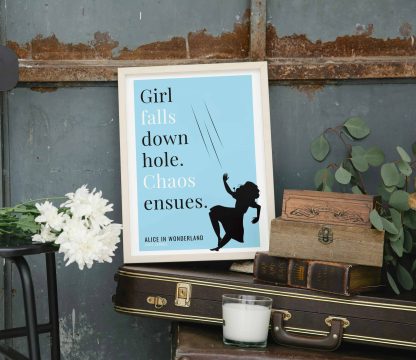 Humorous Alice in Wonderland print in white wooden frame, perched on a violin case next to some books. From Bookish Prints collection by StrangeBooks UK