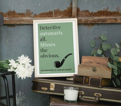 Humorous Adventures of Sherlock Holmes print in white wooden frame, perched on a violin case next to some books. From Bookish Prints collection by StrangeBooks UK