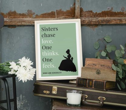 Humorous Sense and Sensibility print in white wooden frame, perched on a violin case next to some books. From Bookish Prints collection by StrangeBooks UK