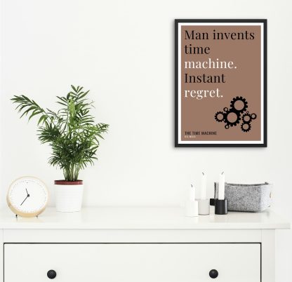Humorous The Time Machine print in black frame on wall, with white chest of drawers and plants and candles below. From Bookish Prints collection by StrangeBooks UK