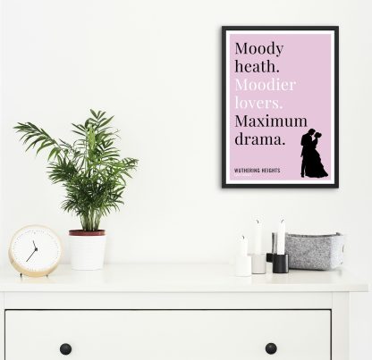 Humorous Wuthering Heights print in black frame on wall, with white chest of drawers and plants and candles below. From Bookish Prints collection by StrangeBooks UK