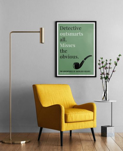 Humorous Adventures of Sherlock Holmes print in black frame on wall, with a yellow armchair in front next to a tall angular lamp and plant on a table. From Bookish Prints collection by StrangeBooks UK